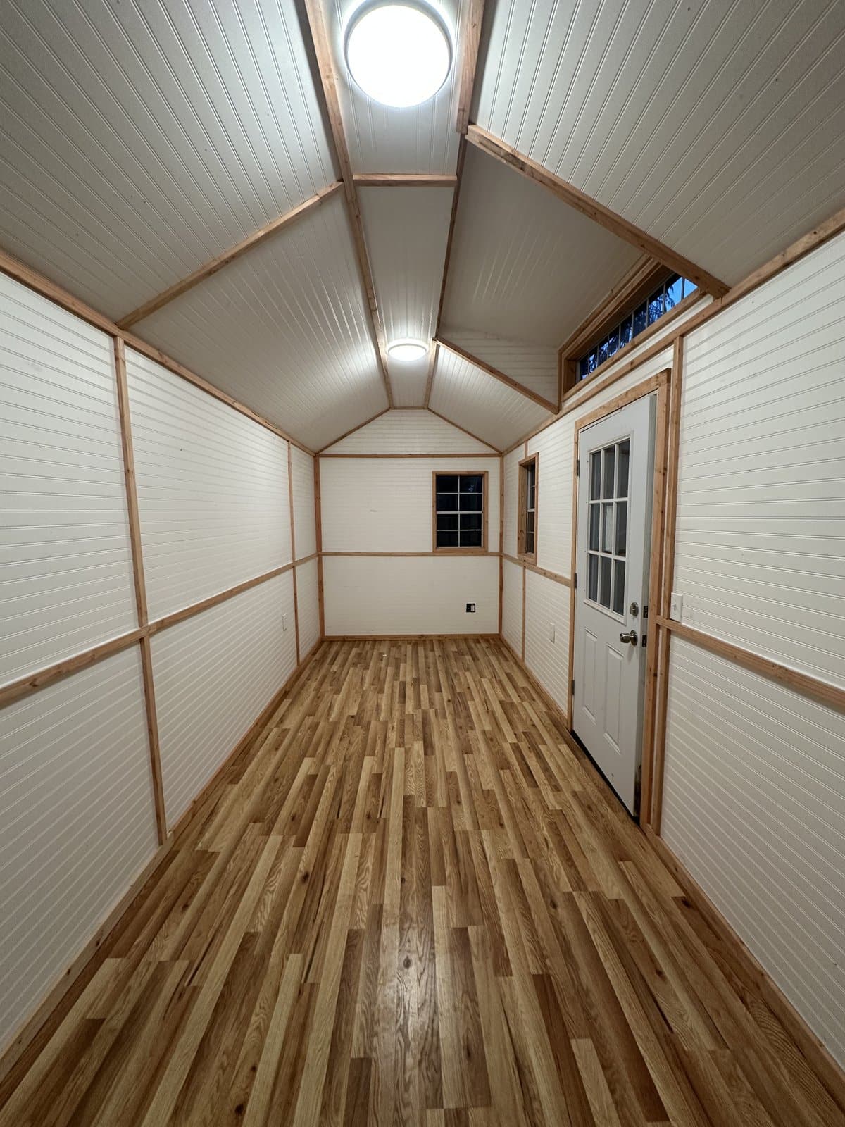Custom shed interior with hardwood floors — built by Gettis Bros