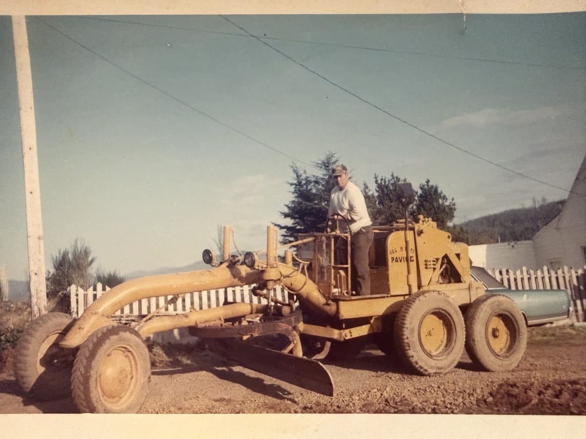 Gettis family operating a road grader — vintage paving on the coast