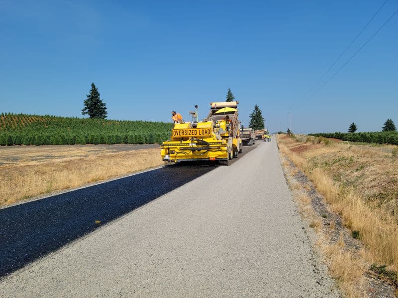 Asphalt paving operation on a rural road near Newport, Oregon